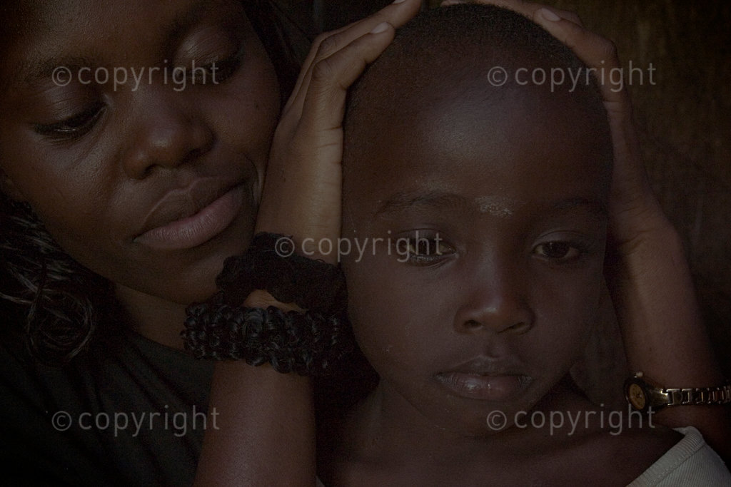 Winnie Otieno (left) is a social worker with the Amani Orphanage. She is holding Manuel Okunga (right), an AIDS orphan who now lives with his one surviving grandparent, herself bed-ridden and chronically ill.
While only 17 children can be funded to live full-time at the orphanage, there are many more orphans in the community which the Amani Child Development Programme attempts to maintain. They are fed once a week at the orphanage and are visited periodically to monitor their health and general condition.
Throughout my time and work in Kenya between 2004 & 2008, it is always the memory of the many bright accentuated smiles that beamed out from many a young face that brightened a dark mood on a bad or dull day.
Often in the face of extreme adversity, children in Kenya, and Africa as a whole always seem to show a remarkable uplifiting spirit.
Maybe it is a desire on my part to try and understand that which makes them so happy, so blissfully at odds with the harsh circumstances that many of these children find themselves that always draws me back to photograph them again and again.
The volume of work has been built up through both personal work and private commissions for the likes of Save the Children, the Clinton Foundation and the World Health Organisation.
