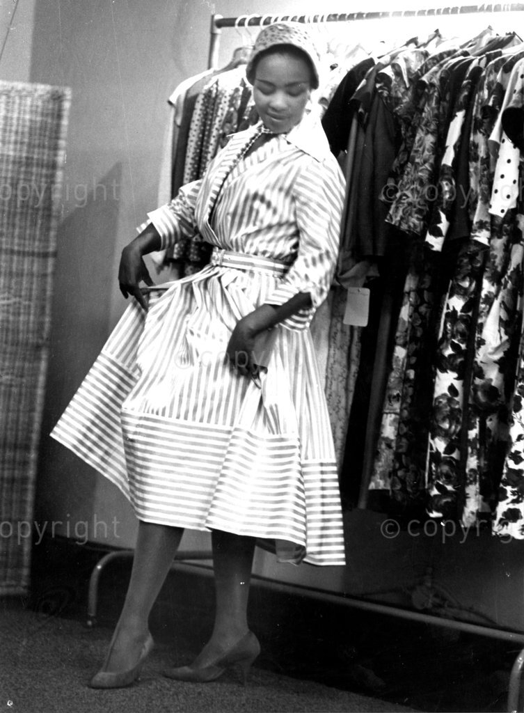 DM2001040305:SAED:SOCIAL:AUG1960 - Real High-Life Dolls - Patty Patience is a full time model in a shop. What beautiful girls! They are all models. And apart from all being stage and recording stars, they have another thing in common: They're all unmarried. (Photographs by Peter Magubane © BAHA) 