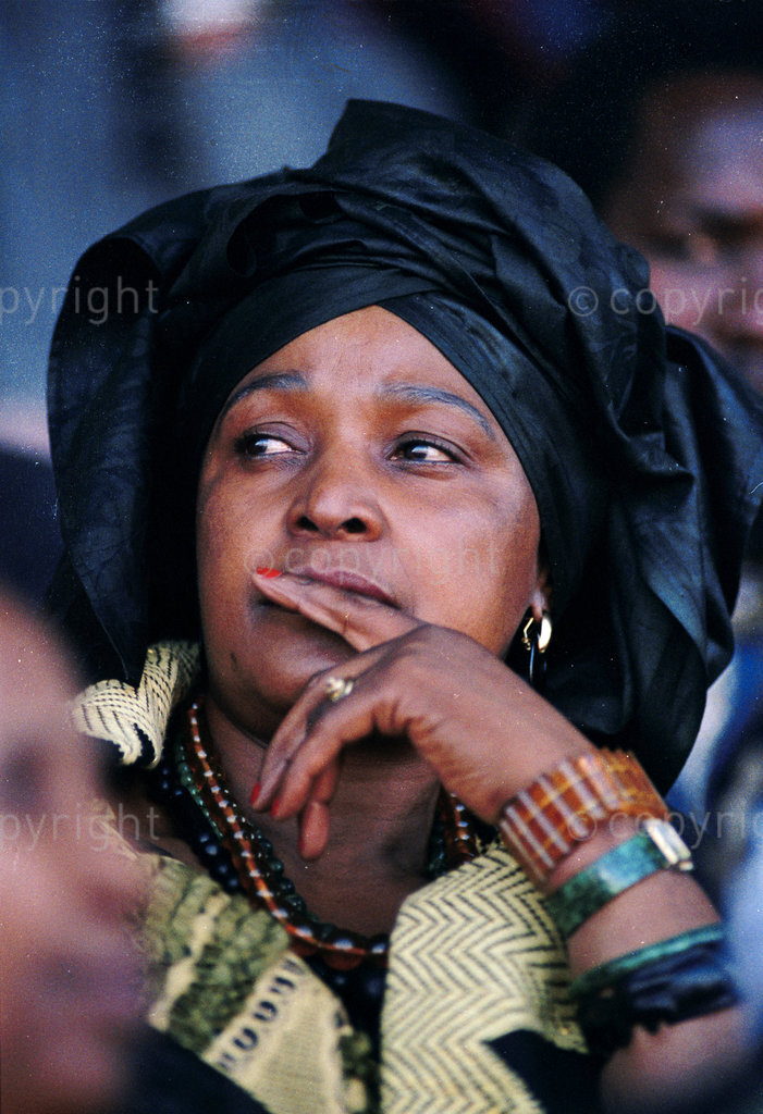 GW0377, South Africa, Durban, 1990: Winnie Mandela at an ANC - African National Congress, Women's league rally. Politic, government, mass meeting, demonstrate, assembly, throng, convention, gathering, crowds, Women's rights groups. Winnie's struggle fashion outfits.
Photograph: Graeme Williams/ South Photographs