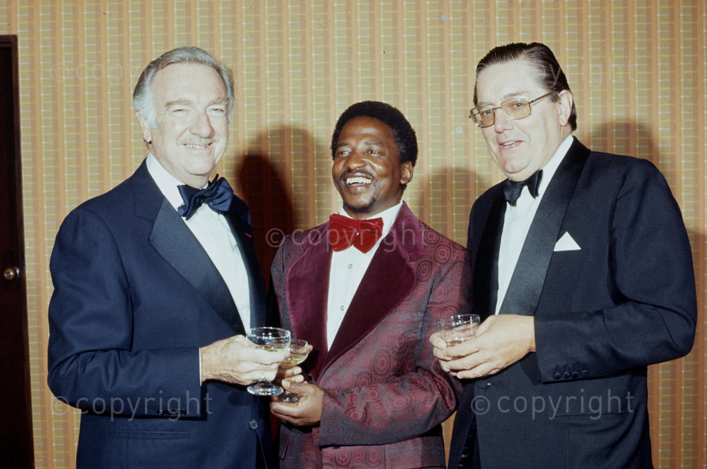The managing director of the Stellenbosch Farmers Winery presents the trophy for enterprising journalism to Rand Daily Mail photographer Peter Magubane on the 21st of February 1977
Photo by Arena Holdings Collection / african.pictures