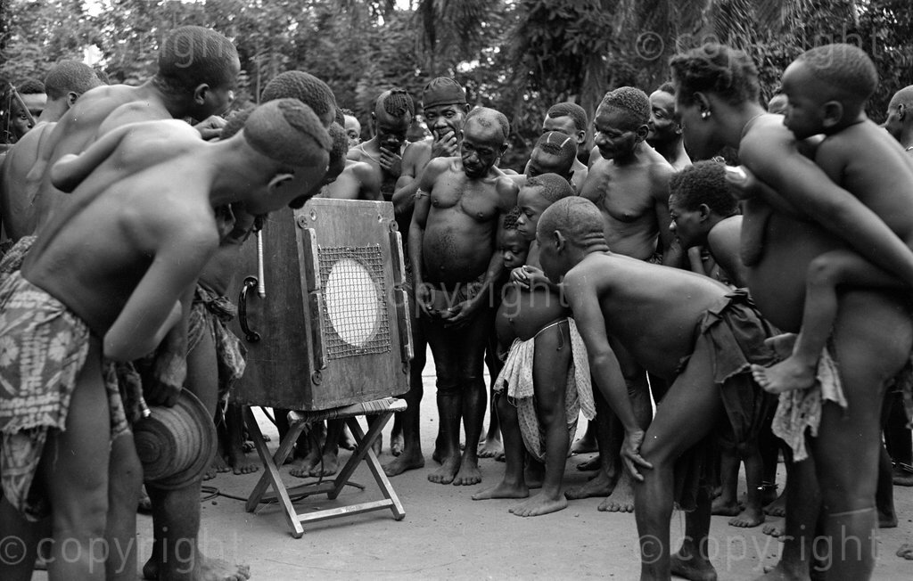 Batwa pygmies listening to a playback of a recording by Hugh Tracey.