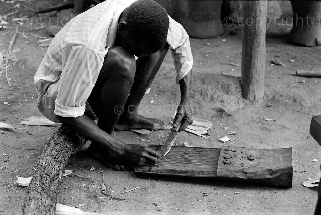 Tuning a bangwe zither.