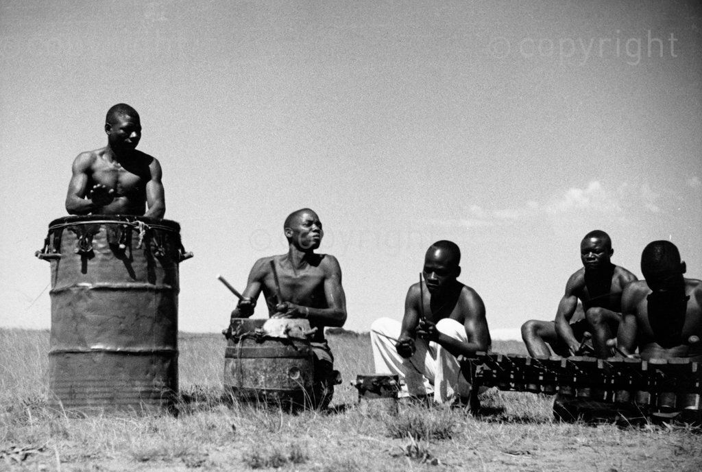 Tswa musicians from Mozambique playing drums and xylophone for mine dancers performing the Tswa Ndzumba dance. Photo found in Hugh Tracey's 'Dances of the Witwatersrand Gold Mines (1952).