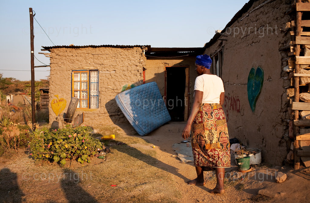 Esther, 56 mother of 3 lives in a mud shack without electricity, running water or a toilet in the shadow of Mbombela Stadium in Mataffin, Nelspruit. The stadium has been built on ancestral land, and the municipality promised the commmunity a better infustrature, new roads, decent housing, electricity, water and sanitation in Mpumalanga in South africa.

“There’s no services here, And still there’s nothing happening. she said. I feel proud that we are hosting this World Cup but I do not have time to think about football. My worries are greater.”
