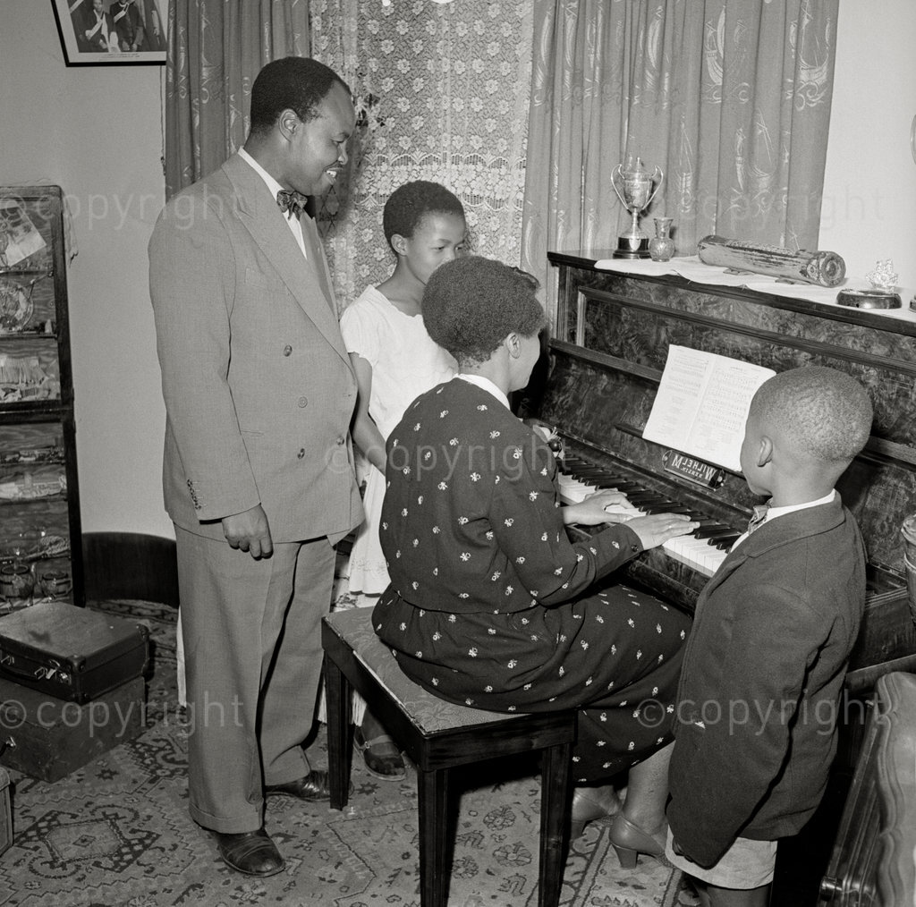 Masterpiece In Bronze – Dan Twala. Family man, Daddy Dan with his brilliant wife Regina, BA in Social Science, and son Vusimuzi, with a friend. Few people in South Africa are so well known as Daniel Reuben Twala. From Cape Town to Johannesburg his name is legend. To the sports fans he is 'Master Sport': to Society he is the 'Man Who Gets Things Done': to the Johannesburg City Council he is the manager of the Johannesburg Bantu Sports Club, one of the most important executive positions in the country.