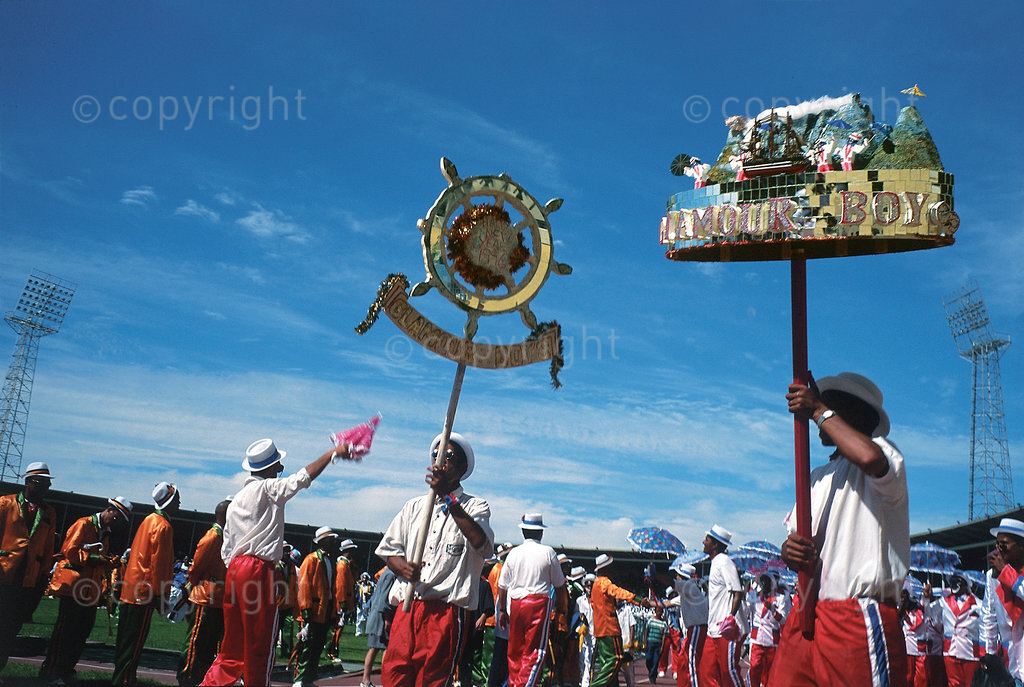 The ‘Glamour Boys’, a minstrel group from the Bo-Kaap, at the 1996 Annual Coon Carnival competitions. The Cape minstrel tradition goes back to the freeing of slaves in the Cape. Today the coons are still made up mainly of working-class people. Unlike in the past when they were funded by their families and supporters in the community, today the klopse are mainly reliant on council and corporate sponsorship for their survival. The cost of material for outfits and transport have become major stumbling blocks for teams wishing to compete.

The Kaapse Klopse (or simply Klopse), formerly known as the Coon Carnival and officially called Cape Town Minstrel Carnival, is a Cape coloured minstrel festival that takes place annually on 2 January in Cape Town, South Africa. It is also referred to as Tweede Nuwe jaar (Second New Year). As many as 13,000 minstrels take to the streets garbed in bright colours, either carrying colourful umbrellas or playing an array of musical instruments. The minstrels are self-organised into klopse (