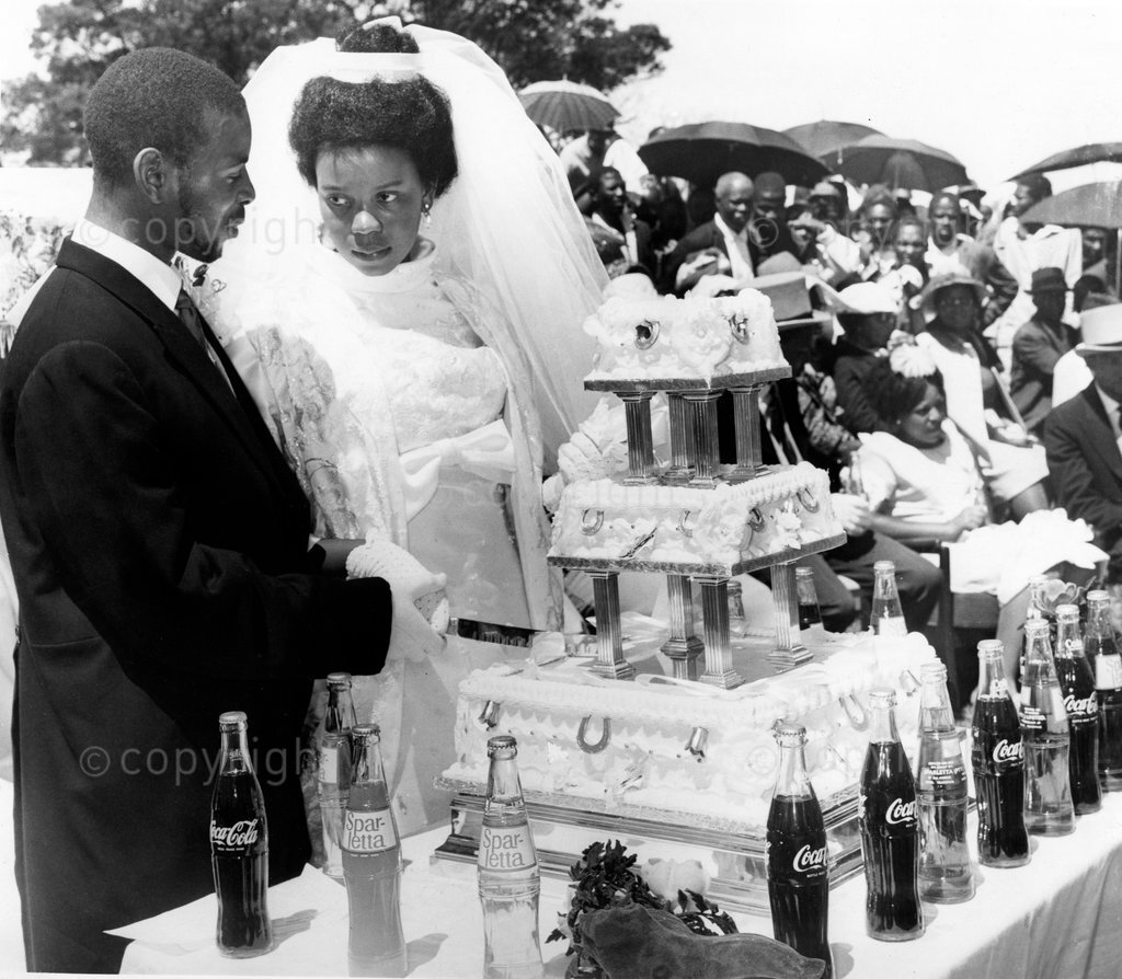 Princess Tells Zulu Secrets – The Prince (Goodwill Zwelithini) and his new wife (Sibongile) pause for a quiet chat before cutting the cake at their wedding party in Nongoma. The rift in the Zulu Royal Family is no secret. But it is also no joke. While the leaders of the most famous African nation south of the Zambezi squabble and plot, three million people are denied political and economic development – even if it is only Bantustan level. Princess Greta, elder sister of the last Paramount Chief, Cyprian Ka Bhekuzulu, and senior aunt of his heir, Prince Goodwill. Her revelations will shock the Zulu nation and its friends.