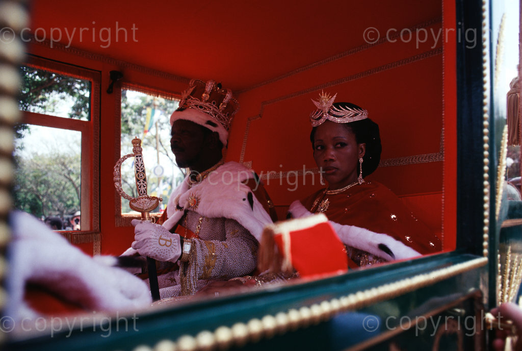Emperor Bokassa dressed in his royal regalia complete with a crown, sword and sceptre rides the royal carriage to the hall accompanied by his Queen for the continuation of the coronation celebrations held on 4th December 1977 at Bangui. (Photo by: Africa 24 Media/Camerapix/Mohamed Amin/Duncan Willetts) ALL RIGHTS RESERVED