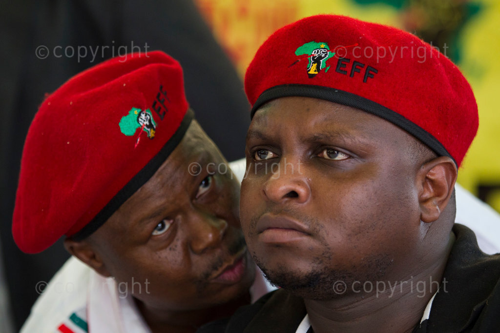 Economic Freedom Fighters National Co-ordinator Mpho Ramakatsa (left) speaks to Commissar for Political Education Floyd Shivambu before handing over a house which they built to a woman living next door to South African President Jacob Zuma in Nkandla, 11 January 2014. © Rogan Ward 2014