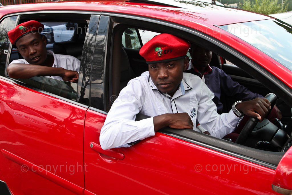 Members of the Economic Freedom Fighters, EFF, the party led by Julius Malema, in berets in a red car while campaigning in Randjesfontein near Midrand ahead of the 2014 national elections in South Africa.
