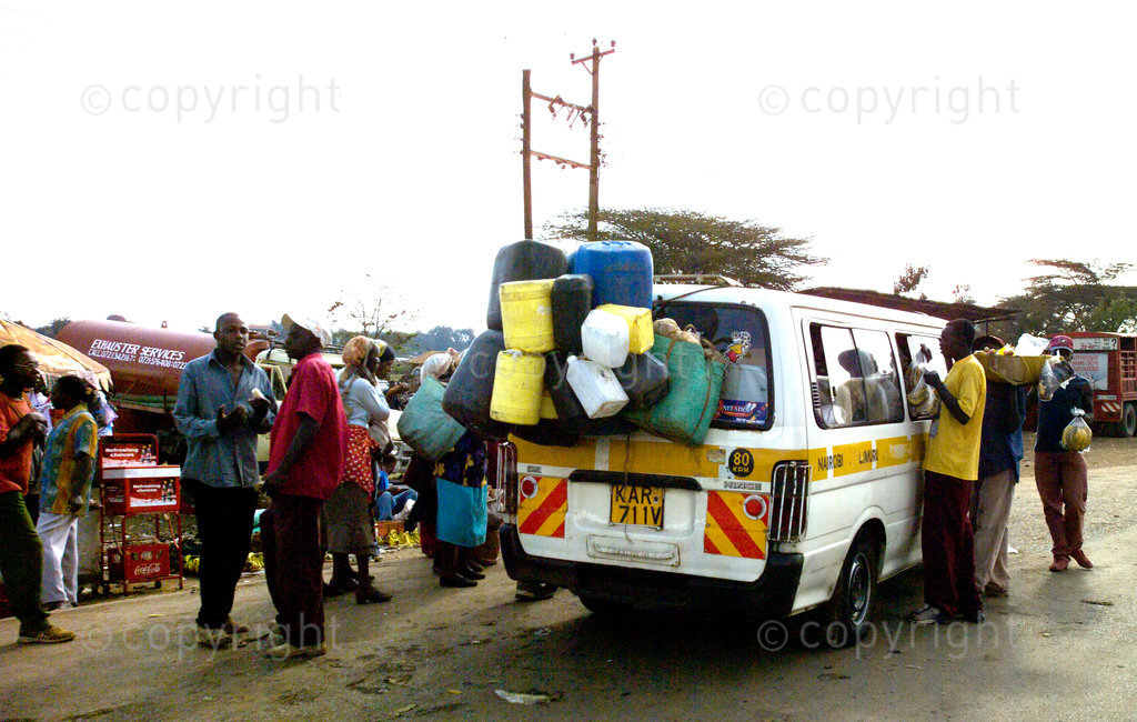 A loaded mini bus taxi stops for passengers in a main road in Kenya.