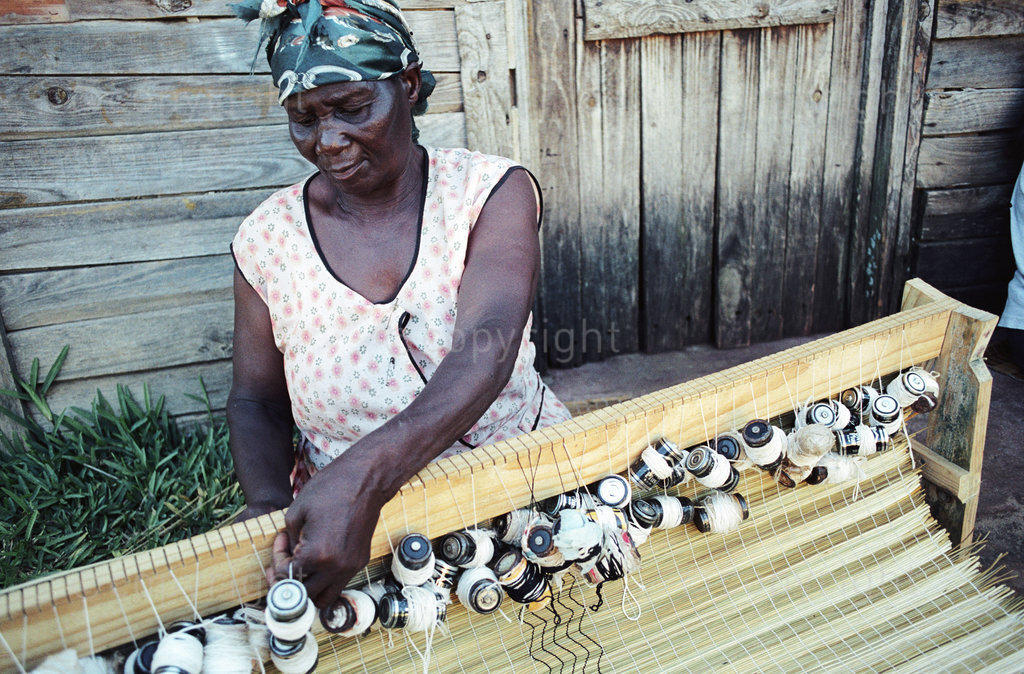 josephina thethwayo, crafts a mat from local reeds