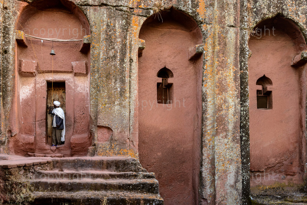 Priets at door to Bete (or Biet) Gebriel-Rufa'el (House of the angels Gabriel, and Raphael). Lalibela. Ethiopia.