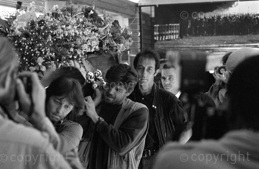 South Africa, 04-1994. Ken Oosterbroek's funeral. Kevin Carter (centre) is one of the pall bearers.
Ken Oosterbroek (born 14/02/63 - died 18/04/94) was an award-winning South African photojournalist and member of The Bang-Bang Club.
Ken was married to journalist Monica Oosterbroek (née Nicolson) from 1991 until his death. He had one daughter, named Tabitha (born 1989), from a previous relationship.
Photo Credit: Ken Oosterbroek / african.pictures Photo Credit: Ken Oosterbroek / african.pictures