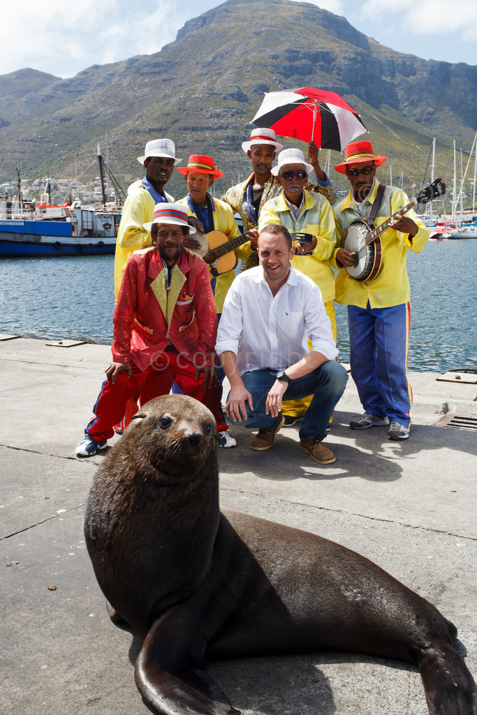 Jan Braai  (real name Jan Scannell) the man behind the National Braai Day initiative poses with a troupe of colourfully dressed Cape Minstrels at Hout Bay Harbour quayside,October 22 2012,Cape Town, Western Cape, South Africa.(Picture: JULIAN GOLDSWAIN)