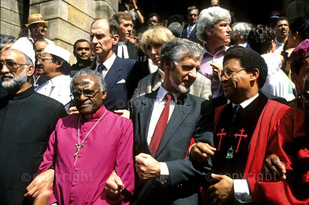 Protest. Politics. Cape Town peace march , Gordon Oliver, Allan Boesak lead the crowd of protestors in March 1989, against Police Brutality. 30000+ people, first legal march. Banner, saying