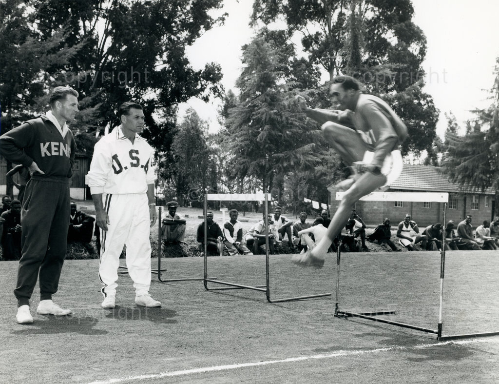 Joseph Lerasae clears the last hurdle as the Kenya and USA Judges look on
