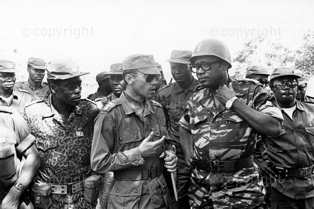 Zaire President Mobutu Sese Seko chats with Commander of the Moroccan troops Col. Loubaris in Shaba Province in Zaire; 1977