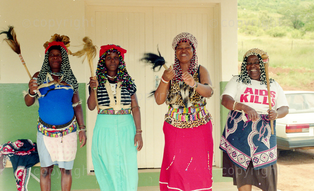 Colour photo of four sangomas dancing with inyanga sticks; Zulu traditional healers talk about their work in plant conservation and primary health care including AIDS, Zululand, South Africa; documentary; 1998