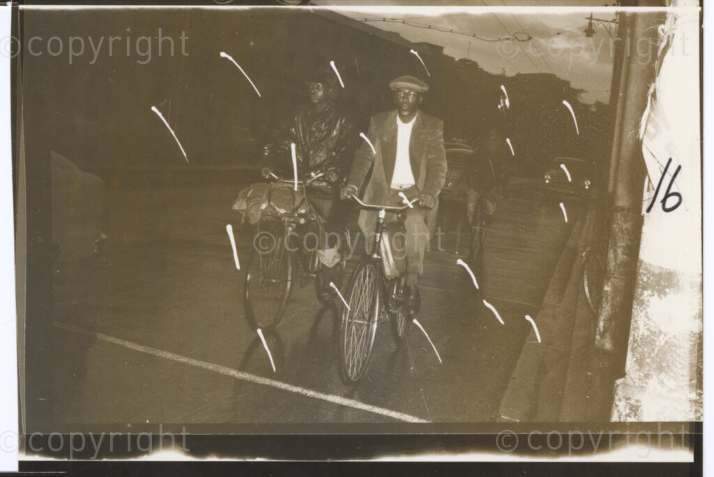 Johannesburg, Transvaal (now Gauteng), South Africa, 19570101. PHOTO: Eli Weinberg.

Three people cycle along a road in the dark somewhere in the Transvaal (now Gauteng). This is possibly part of the Bus Boycott during 1956 and 1957 when The Putco Bus Company, the main transport company in the Witwatersrand increased bus fares and in response many people boycotted the buses in protest and walked, cycled or used taxis to get to work instead, often leaving very early in the morning.