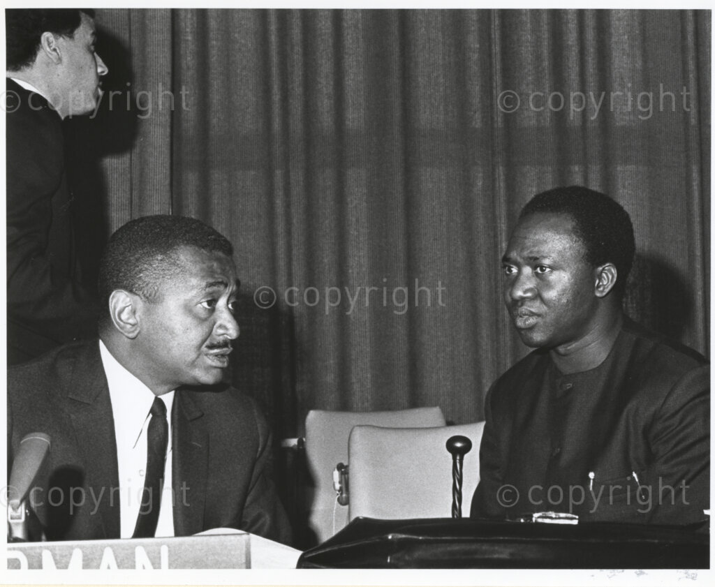 United Nations, New York, New York, United States of America, 19670321. PHOTO: ANC Archives.

Achkar Marof (left), Chairman of the Special Committee Against Apartheid, and John Malecela (right), Tanzanian Permanent Representative to the United Nations, at the United Nations in New York, 21 March 1967. This photograph forms part of a series of captioned photographic records titled “The United Nations and Apartheid”, that was presented to Nelson Mandela, President of the Republic of South Africa, by United Nations Secretary-General Boutros Boutros-Ghali in October 1994.