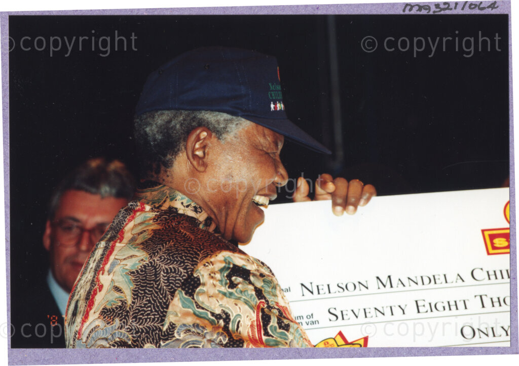 Hilton College, Pietermaritzburg, KwaZulu-Natal, South Africa, 19960717. PHOTO: ANC Archives.

The President of South Africa, Nelson Mandela, receives a donation of R78 000 towards the Nelson Mandela Children's Fund at his 78th birthday celebration on the 17th July 1996 on the grounds of Hilton College near Pietermaritzburg in the KwaZulu-Natal Midlands. More than 2,000 children who are living with disability in disadvantaged communities have come from across the country to celebrate Madiba's birthday with him. Nelson Mandela took the opportunity to speak to sponsors and business people gathered for the event about the importance of civil society working together to ensure that the needs of disabled children are incorporated into every programme for children.