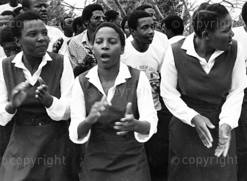 Mazimbu/Dakawa, Morogoro, Tanzania, Late 1970’s - 1980’s. PHOTO: ANC Archives.

Solomon Mahlangu Freedom College (SOMAFCO) students, some in school uniform, clapping and singing.