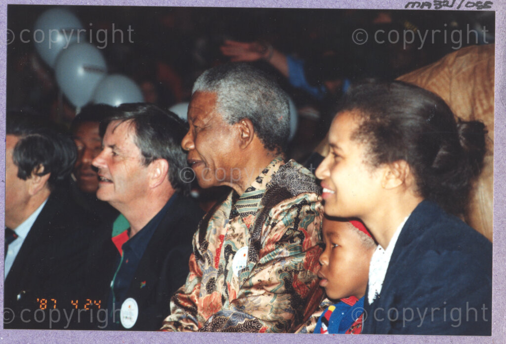 Hilton College, Pietermaritzburg, KwaZulu-Natal, South Africa, 19960717. PHOTO: ANC Archives.

Seated among his guests and with his grandson next to him (second right), the President of South Africa, Nelson Mandela (centre), enjoys a circus performance in the big top tent erected for his 78th birthday celebration on the 17th July 1996 on the grounds of Hilton College near Pietermaritzburg in the KwaZulu-Natal Midlands. More than 2,000 children who are living with disability in disadvantaged communities have come from across the country to celebrate Madiba's birthday with him. The circus experience is a first for most of the children, as well as for the country's president! Later in the day, Nelson Mandela took the opportunity to speak to sponsors and business people gathered for the event about the importance of civil society working together to ensure that the needs of disabled children are incorporated into every programme for children. The event has the backing of the Nelson Mandela Children's Fund.