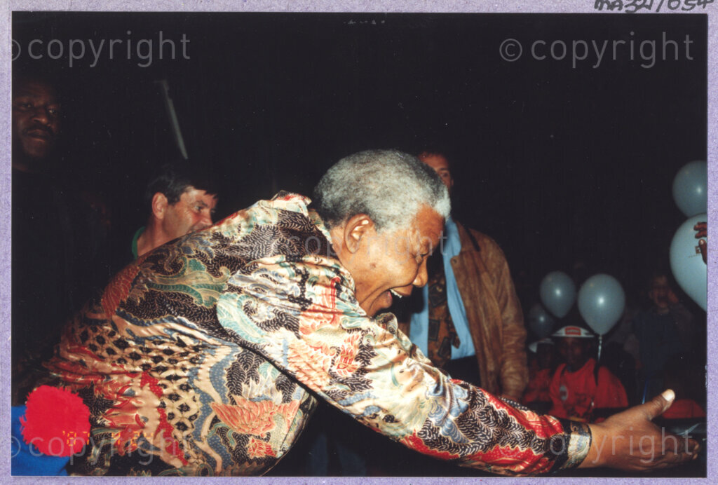 Hilton College, Pietermaritzburg, KwaZulu-Natal, South Africa, 19960717. PHOTO: ANC Archives.

Seated among his guests, the President of South Africa, Nelson Mandela, enjoys a circus performance in the big top tent erected for his 78th birthday celebration on the 17th July 1996 on the grounds of Hilton College near Pietermaritzburg in the KwaZulu-Natal Midlands. More than 2,000 children who are living with disability in disadvantaged communities have come from across the country to celebrate Madiba's birthday with him. The circus experience is a first for most of the children, as well as for the country's president! Later in the day, Nelson Mandela took the opportunity to speak to sponsors and business people gathered for the event about the importance of civil society working together to ensure that the needs of disabled children are incorporated into every programme for children. The event has the backing of the Nelson Mandela Children's Fund.