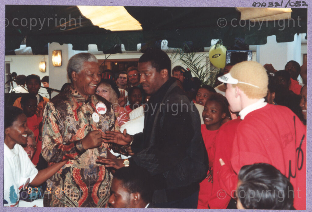Hilton College, Pietermaritzburg, KwaZulu-Natal, South Africa, 19960717. PHOTO: ANC Archives.

The President of South Africa, Nelson Mandela, mingles with his guests after enjoying a circus performance in the big top tent erected for his 78th birthday celebration on the 17th July 1996 on the grounds of Hilton College near Pietermaritzburg in the KwaZulu-Natal Midlands. More than 2,000 children who are living with disability in disadvantaged communities have come from across the country to celebrate Madiba's birthday with him. The circus experience is a first for most of the children, as well as for the country's president! Later in the day, Nelson Mandela took the opportunity to speak to sponsors and business people gathered for the event about the importance of civil society working together to ensure that the needs of disabled children are incorporated into every programme for children. The event has the backing of the Nelson Mandela Children's Fund.