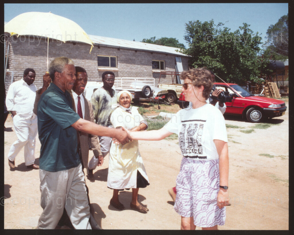 Jane Furse Agricultural Center, Jane Furse town, Sekhukhuneland, Transvaal, South Africa, 19921130. PHOTO: ANC Archives.

Operational Hunger Administrator (for the Northern Transvaal), Belinda Blaine (right), greets the African National Congress President, Nelson Mandela (left), at the Jane Furse Agricultural Center, Sekhukhuland in November 1992.