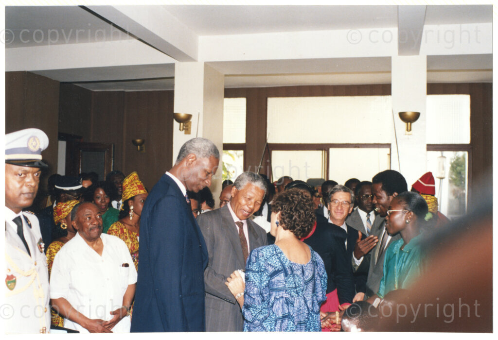 Senegal  , 19920601. PHOTO: ANC Archives.

A photo with Alfred Nzo (second row, second from left with white shirt), Senegalese President, Abdou Diouf (front left) and Nelson Mandela (second from left) greeting an unidentified woman during Mandela's visit to Senegal in June 1992.