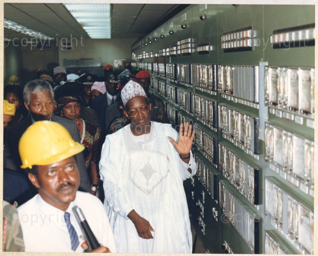 Kaduna Refinery, Kaduna, Kaduna, Nigeria, 19900515. PHOTO: ANC Archives.

Nelson Mandela (second left), with Winnie Madikizela-Mandela behind him, listens to an official during their visit to Kaduna Refinery, Nigeria, 15 May 1990.
