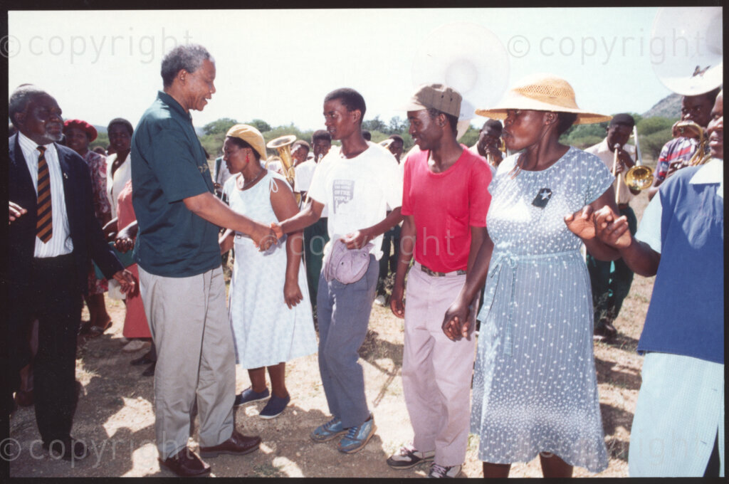Steelpoort Airstrip , Sekhukhuneland, Transvaal, South Africa, 19921130. PHOTO: ANC Archives.

The President of the African National Congress (ANC), Nelson Mandela (second left) greets Operation Hunger staff at Steelpoort Airstrip in November 1992, having just landed and about to start a tour of the Organisation's programs that operate in nearby Sekhukhuneland villages.