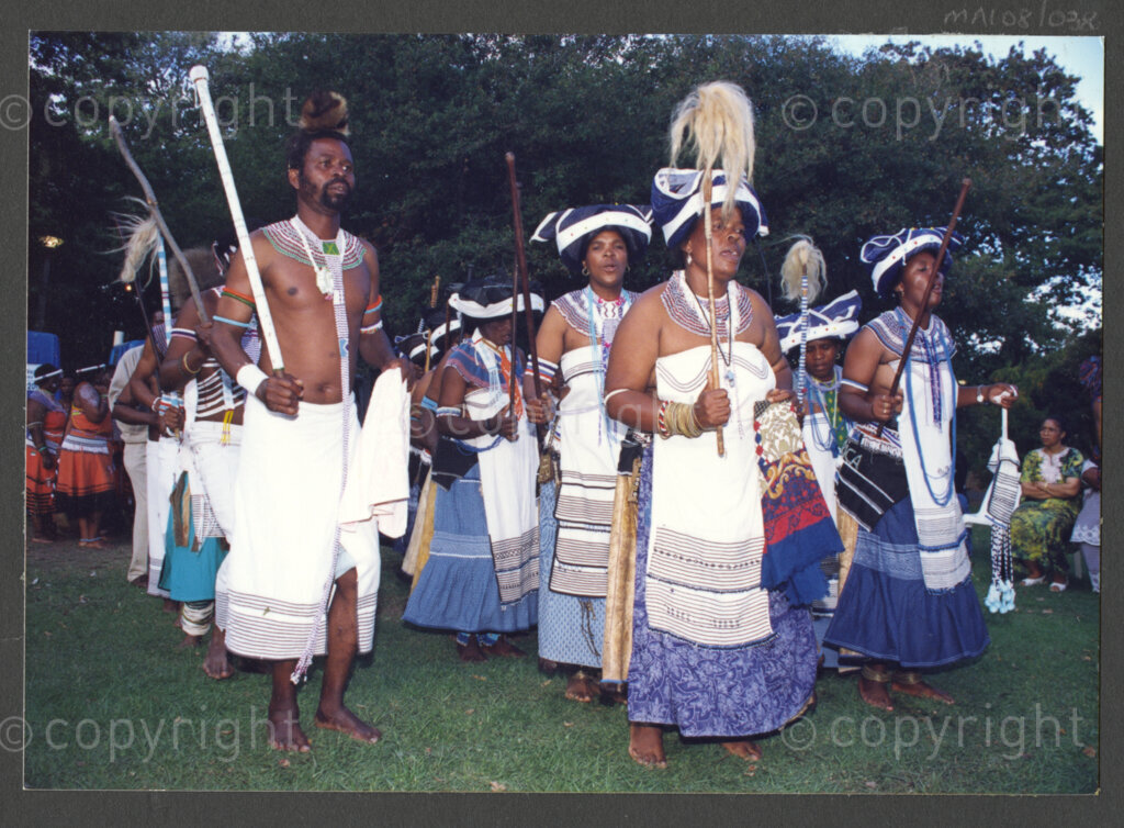 Cape Town, Western Cape, South Africa, 19970418. PHOTO: ANC Archives.

A group of Xhosa men and women from the Eastern Cape dressed in traditional attire, their outfits and beadwork predominantly blue and white, and some bearing knobkerries, perform at the inauguration of the Council of Traditional Leaders in Cape Town, Western Cape, South Africa on 18 April 1997.