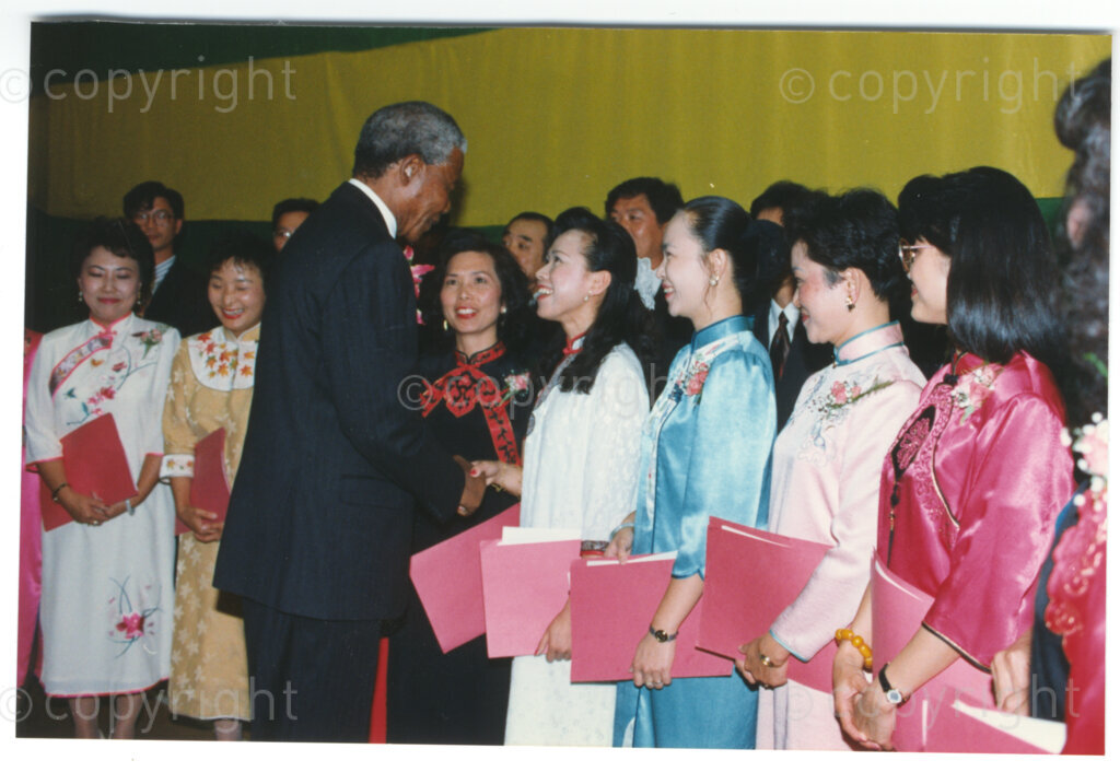 Parktonian Hotel, Johannesburg, Transvaal, South Africa, 19940309. PHOTO: ANC Archives.

The President of the African National Congress (ANC), Nelson Mandela, greets young women dressed in traditional Taiwanese dress at an ANC voter education fund-raising dinner hosted by the Taiwanese community in South Africa on the 9 March 1994. Leading up to the 1994 elections in South Africa, Taiwan embarked on a public relations campaign in efforts to improve relations with the ANC, providing financial support to the ANC's election campaign. South Africa's diplomatic ties with Taiwan (The Republic of China) ended in 1998 however when Nelson Mandela, as President of South Africa, recognized the People's Republic of China.