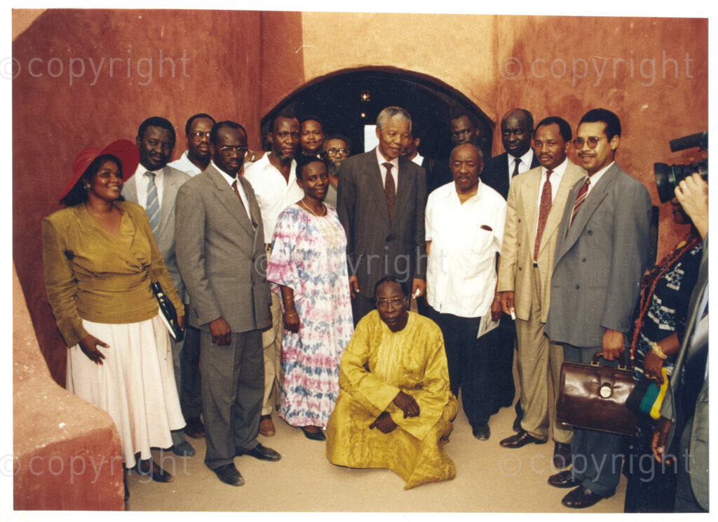 Senegal, 19920601. PHOTO: ANC Archives.

A group photo with Nelson Mandela (centre) and Alfred Nzo (Right of Mandela, with white shirt) during Mandela's official visit to Senegal n June 1992.