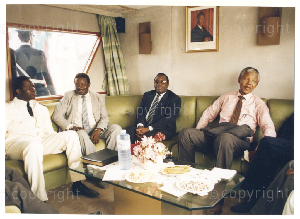 Senegal, 19920601. PHOTO: ANC Archives.

Nelson Mandela (right) is seen sitting next to unidentified men (left), during Mandela’s visit to Senegal in June 1992.
