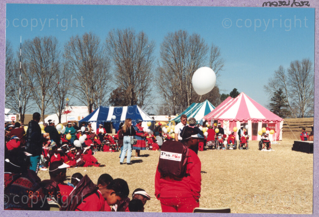 Hilton College, Pietermaritzburg, KwaZulu-Natal, South Africa, 19960717. PHOTO: ANC Archives.

Festive circus-top style tents have been erected for the 78th birthday celebration of the President of South Africa, Nelson Mandela. The tents house different food stalls and activities for the enjoyment of the invited guests, namely the more than 2,000 children who are living with disability in disadvantaged communities across the county. The day-long birthday extravaganza is being held on the 17th July 1996 on the grounds of Hilton College near Pietermaritzburg in the KwaZulu-Natal Midlands. The children, their carers, Madiba and other guests are being entertained playing games, enjoying party fare, and attending a circus performance in a big top (a first-time experience for Madiba who has, to date, never been to a circus!). The event has the backing of the Nelson Mandela Children's Fund.