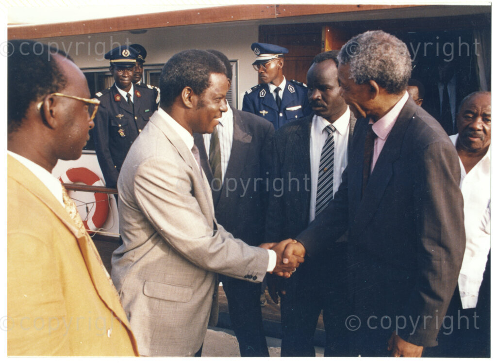 Senegal, 19920601. PHOTO: ANC Archives.

Alfred Nzo (back, right with the white shirt) and Nelson Mandela (front, right) greeting an unidentified man (left) during his visit to Senegal in June 1992.
