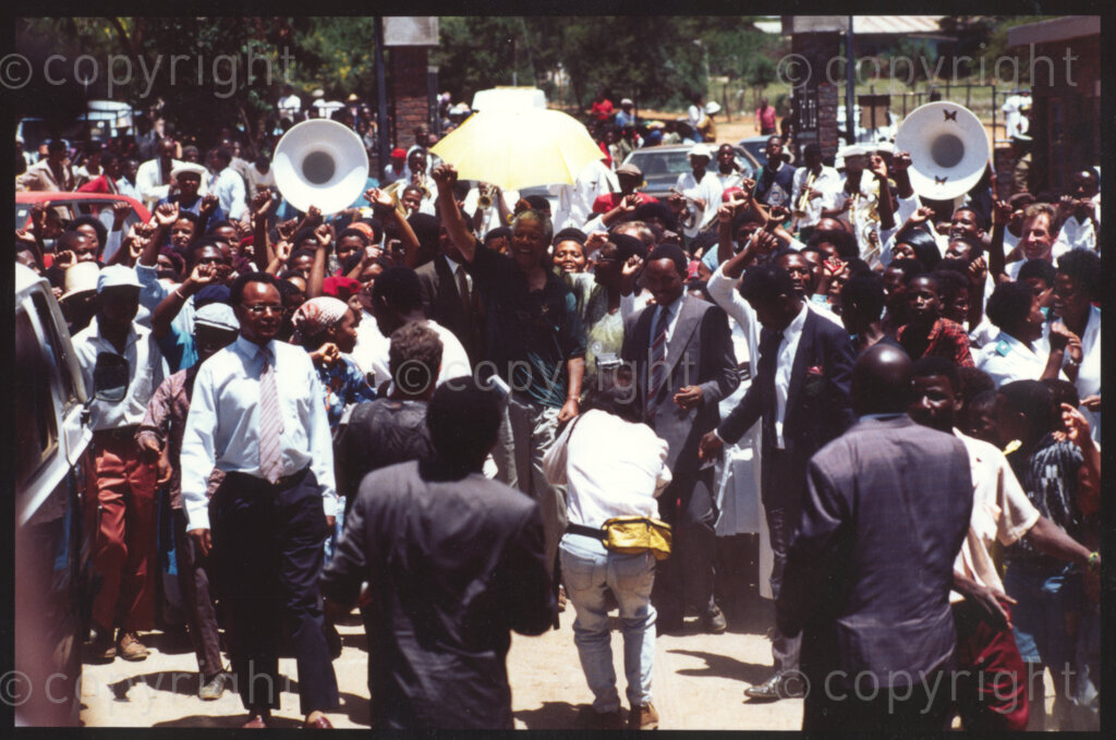 Jane Furse Hospital, Jane Furse town, Sekhukhuneland, Transvaal, South Africa, 19921130. PHOTO: ANC Archives.

Crowds escort the President of the African National Congress, Nelson Mandela (centre), through the grounds of the Jane Furse Hospital on a visit to the town in the Sekhukhuneland region in November 1992.