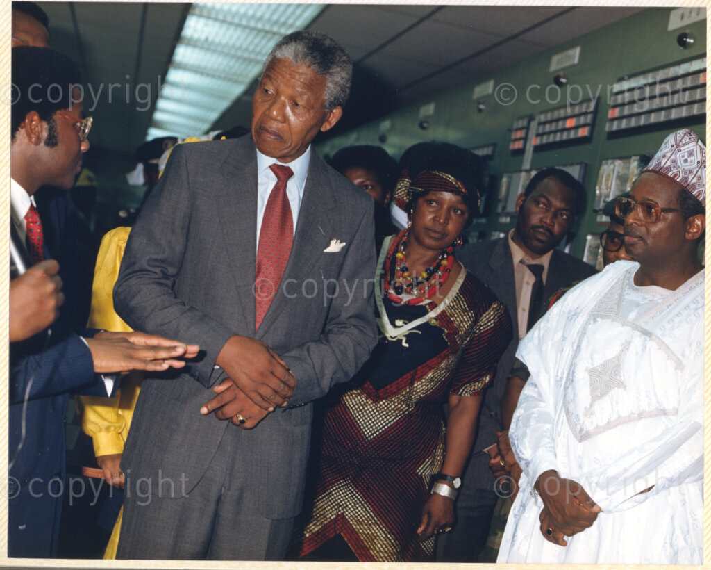 Kaduna Refinery, Kaduna, Kaduna, Nigeria, 19900515. PHOTO: ANC Archives.

Nelson Mandela and Winnie Madikizela-Mandela listen to officials during their tour of Kaduna Refinery, Nigeria, 15 May 1990.