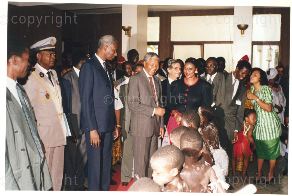 Senegal, 19920601. PHOTO: ANC Archives.

Nelson Mandela (centre), standing next to Senegalese President, Abdou Diouf (left from Mandela), is seen greeting children in traditional costume, during his visit to Senegal in June 1992.