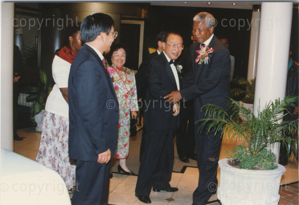 Parktonian Hotel, Johannesburg, Transvaal, South Africa, 19940309. PHOTO: ANC Archives.

The President of the African National Congress (ANC), Nelson Mandela (right) is greeted by his Taiwanese hosts as he arrives at an ANC voter education fund-raising dinner hosted by the Taiwanese community in South Africa on the 9 March 1994. Leading up to the 1994 elections in South Africa, Taiwan embarked on a public relations campaign in efforts to improve relations with the ANC, providing financial support to the ANC's election campaign. South Africa's diplomatic ties with Taiwan (The Republic of China) ended in 1998 however when Nelson Mandela, as President of South Africa, recognized the People's Republic of China.