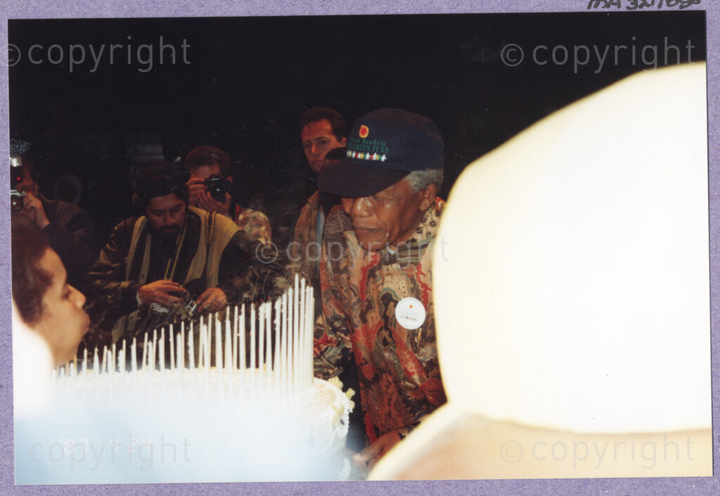 Hilton College, Pietermaritzburg, KwaZulu-Natal, South Africa, 19960717. PHOTO: ANC Archives.

The President of South Africa, Nelson Mandela, blows out the 78 candles on his 100kg birthday cake. Nelson Mandela is celebrating his 78th birthday with more than 2,000 children who are living with disability in disadvantaged communities across the county. The day-long birthday extravaganza is being held on the 17th July 1996 on the grounds of Hilton College near Pietermaritzburg in the KwaZulu-Natal Midlands. The event has the backing of the Nelson Mandela Children's Fund.