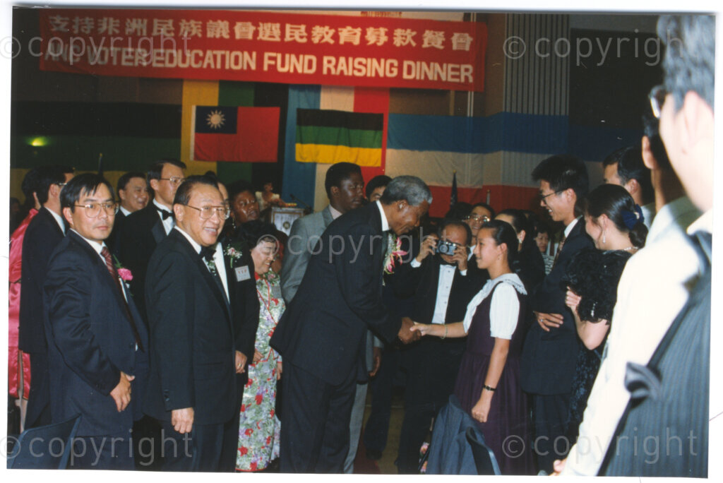 Parktonian Hotel, Johannesburg, Transvaal, South Africa, 19940309. PHOTO: ANC Archives.

The President of the African National Congress (ANC), Nelson Mandela, greets a child at an ANC voter education fund-raising dinner hosted by the Taiwanese community in South Africa on the 9 March 1994. Leading up to the 1994 elections in South Africa, Taiwan embarked on a public relations campaign in efforts to improve relations with the ANC, providing financial support to the ANC's election campaign. South Africa's diplomatic ties with Taiwan (The Republic of China) ended in 1998 however when Nelson Mandela, as President of South Africa, recognized the People's Republic of China.