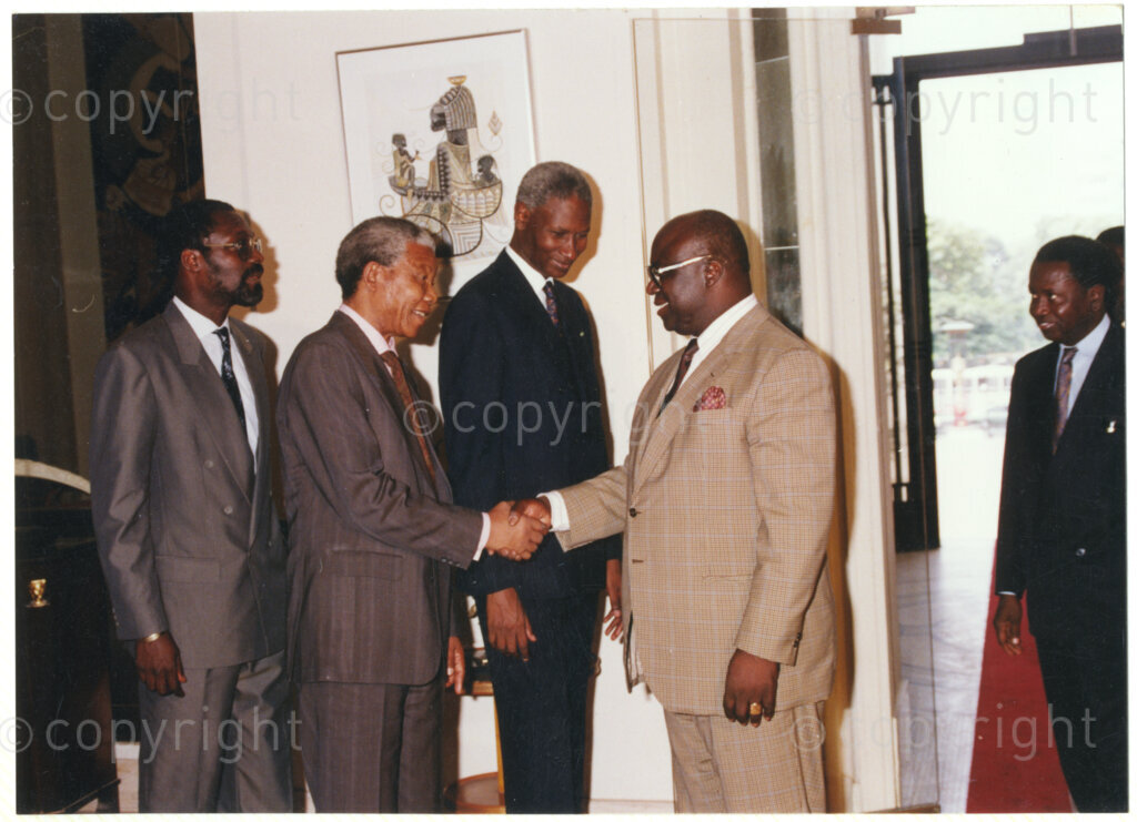Senegal  , 19920601. PHOTO: ANC Archives.

Senegalese President, Abdou Diouf (centre) looks on as Nelson Mandela (second, left) is greeted by an unidentified man, during Mandela's visit to Senegal in June 1992.