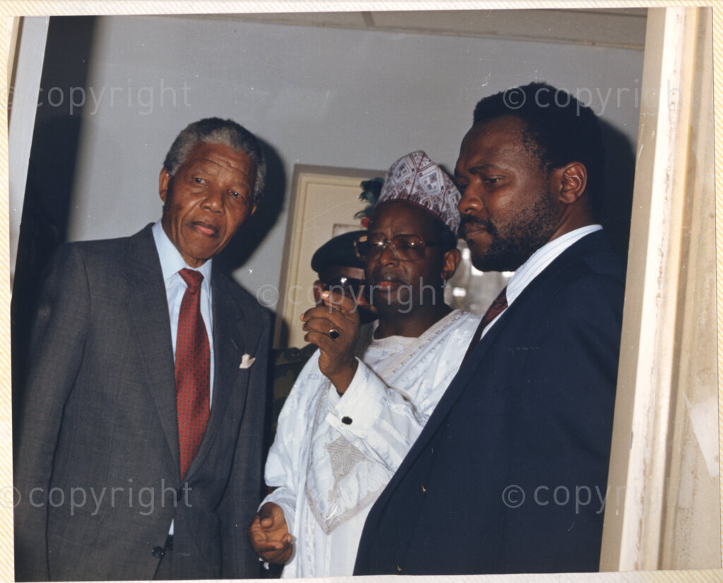 Kaduna Refinery, Kaduna, Kaduna, Nigeria, 19900515. PHOTO: ANC Archives.

Nelson Mandela (left) and two unidentified individuals in conversation during his visit to Kaduna Refinery, Nigeria, 15 May 1990.