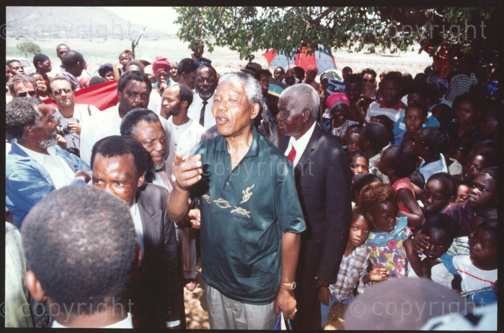 Maila Mapitsane village, Sekhukhuneland region, Transvaal, South Africa, 19921130. PHOTO: ANC Archives.

President of the ANC, Nelson Mandela (centre) meets with the Chief of the Maila Mapitsane Village (behind Mandela, wearing a red tie), and the village's community in the Sekhukhuneland region in November 1992.