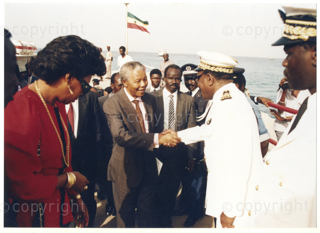 Senegal, 19920601. PHOTO: ANC Archives.

Nelson Mandela (Centre) seen on a boat, greeting an unidentified Senegalese official (Front, second from right) on his official visit to Senegal in June 1992.